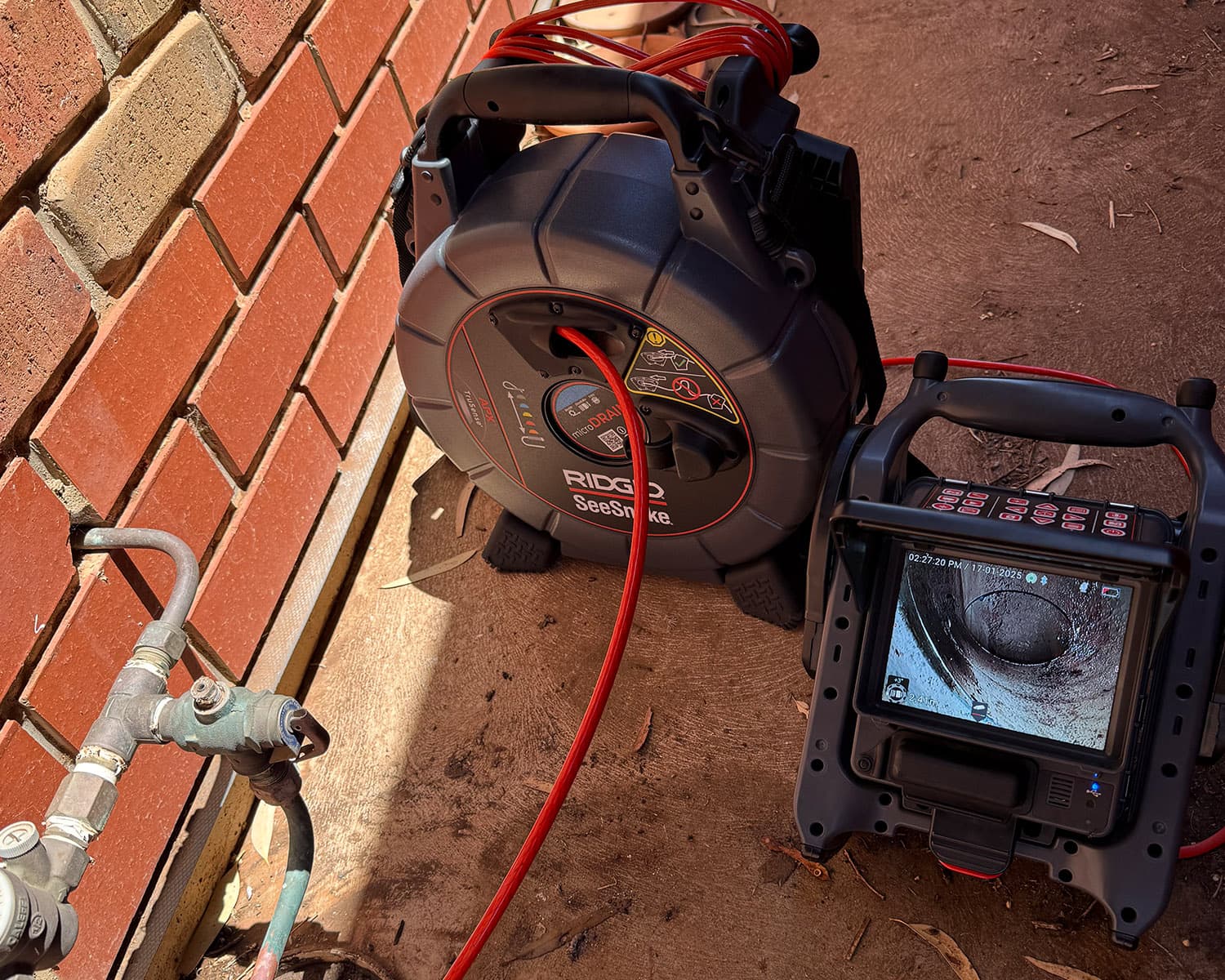 RIDGID SeeSnake drain camera and jetting reel set up on site for a drain inspection